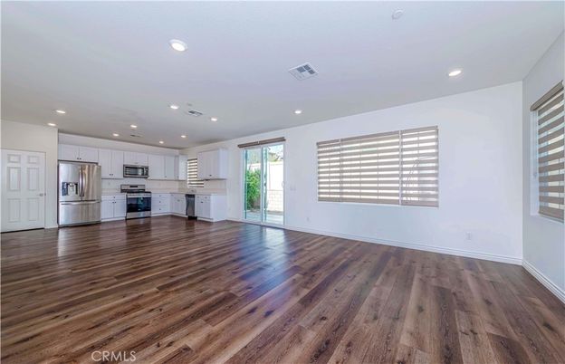 Empty room, Interior, Kitchen, Recessed Lighting, Stainless Steel Appliances, Wood Texture Flooring