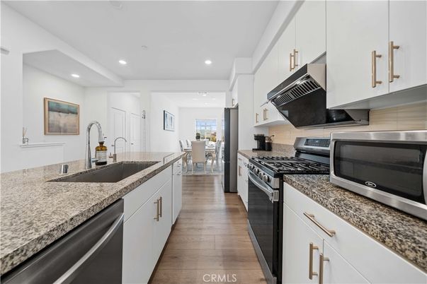 Dining room, Interior, Kitchen, Recessed Lighting, Stainless Steel Appliances, Wood Texture Flooring