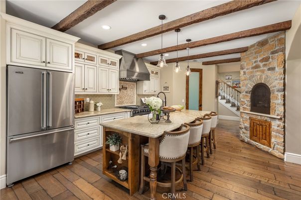 Fireplace, Interior, Kitchen, Pendant Lights, Recessed Lighting, Stainless Steel Appliances, Stone Walls, Wooden Beams, Wood Texture Flooring