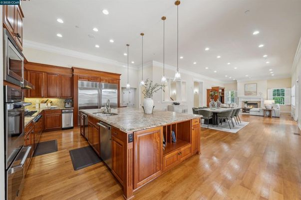 Dining room, Fireplace, Interior, Kitchen, Living room, Pendant Lights, Recessed Lighting, Stainless Steel Appliances, Wood Texture Flooring