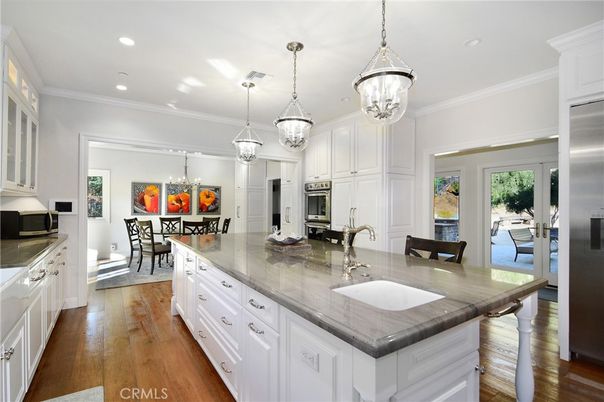 Chandelier, Dining room, Interior, Kitchen, Pendant Lights, Recessed Lighting, Stainless Steel Appliances, Wood Texture Flooring