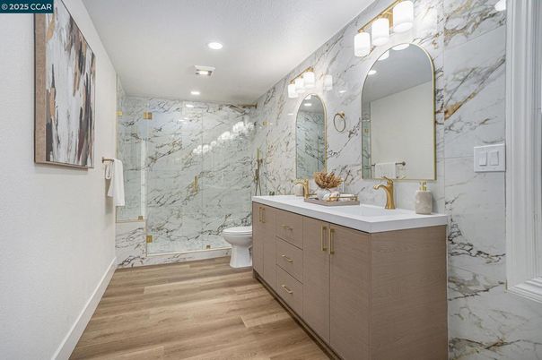 Bathroom, Dual Sink Vanities, Interior, Marble Walls, Recessed Lighting, Wood Texture Flooring