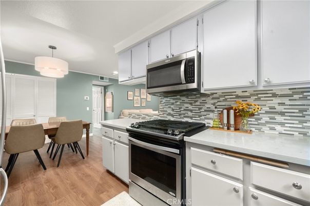 Dining room, Interior, Kitchen, Pendant Lights, Recessed Lighting, Stainless Steel Appliances, Wood Texture Flooring