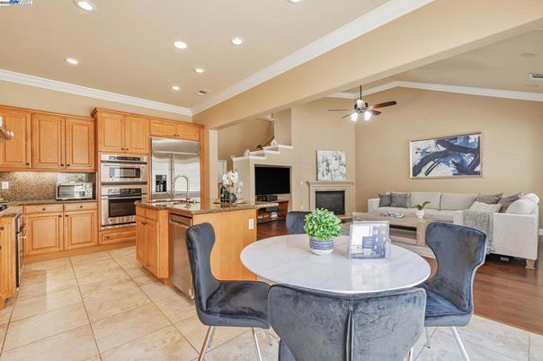 Dining room, Fireplace, Interior, Kitchen, Living room, Recessed Lighting, Stainless Steel Appliances, Wood Texture Flooring