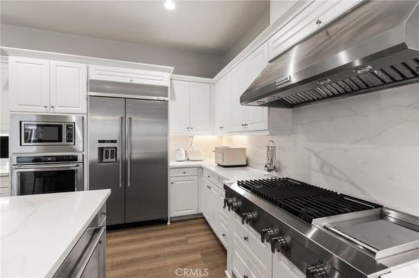 Interior, Kitchen, Marble Walls, Recessed Lighting, Stainless Steel Appliances, Wood Texture Flooring