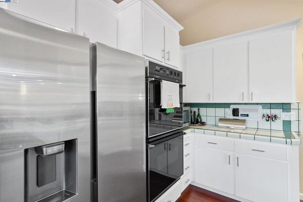 Interior, Kitchen, Stainless Steel Appliances, Tile Countertops, Wood Texture Flooring