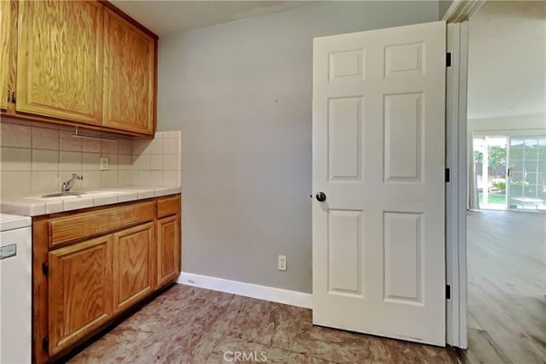 Interior, Kitchen, Recessed Lighting, Tile Countertops, Wood Texture Flooring