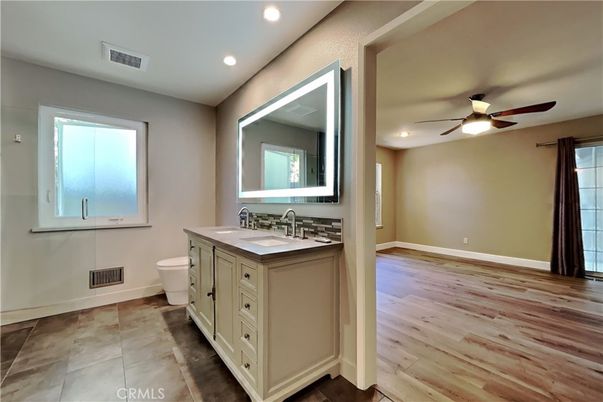 Bathroom, Dual Sink Vanities, Interior, Recessed Lighting, Wood Texture Flooring