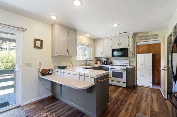 Interior, Kitchen, Recessed Lighting, Tile Countertops, Wood Texture Flooring