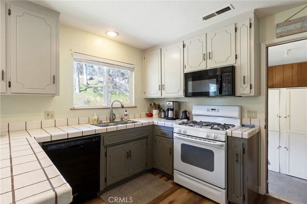 Interior, Kitchen, Recessed Lighting, Tile Countertops, Wood Texture Flooring