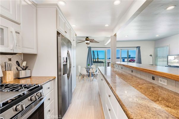 Dining room, Interior, Kitchen, Recessed Lighting, Stainless Steel Appliances, Water, Wood Texture Flooring