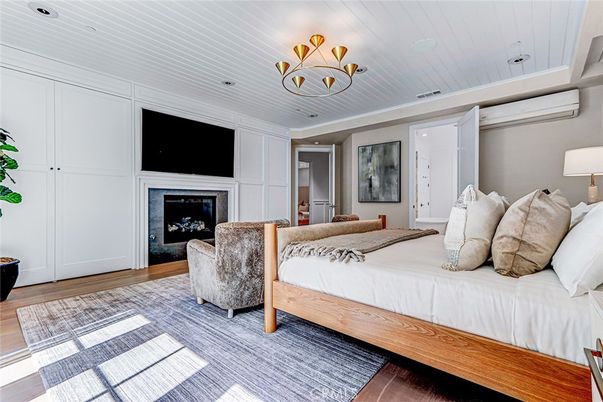 Bedroom, Chandelier, Fireplace, Interior, Recessed Lighting, Wood Texture Flooring