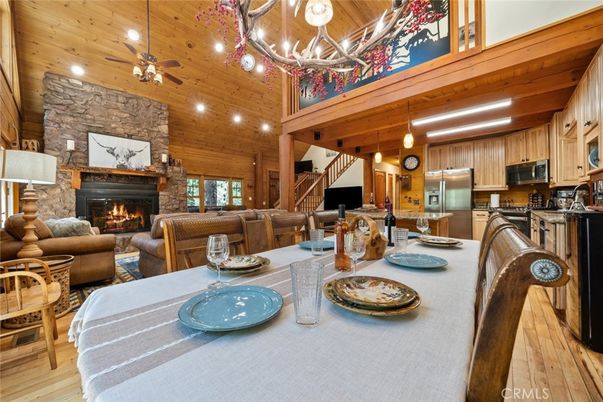 Chandelier, Dining room, Fireplace, Interior, Kitchen, Living room, Recessed Lighting, Stainless Steel Appliances, Stone Walls, Wooden Beams, Wooden Ceilings, Wood Texture Flooring, Wooden Walls