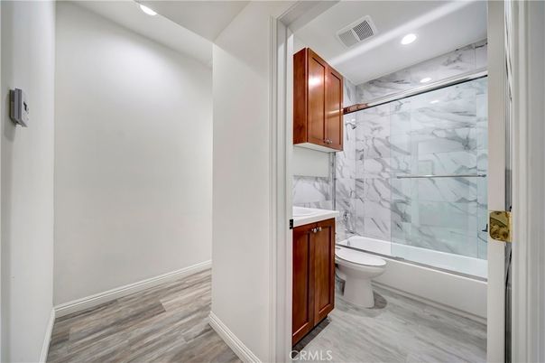 Bathroom, Glass Shower, Interior, Marble Walls, Recessed Lighting, Wood Texture Flooring
