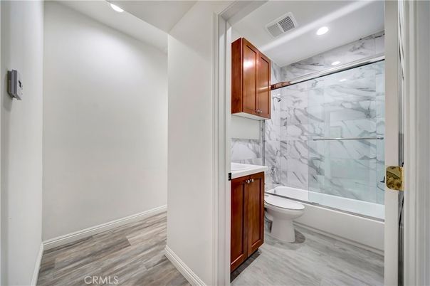 Bathroom, Glass Shower, Interior, Marble Walls, Recessed Lighting, Wood Texture Flooring