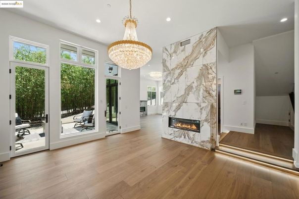 Chandelier, Fireplace, Interior, Marble Walls, Recessed Lighting, Wood Texture Flooring
