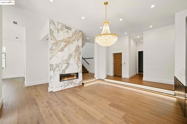 Chandelier, Fireplace, Interior, Marble Walls, Recessed Lighting, Wood Texture Flooring