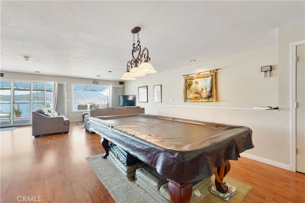 Billiard Table, Chandelier, Game Room, Interior, Living room, Pendant Lights, Recessed Lighting, Water, Wood Texture Flooring