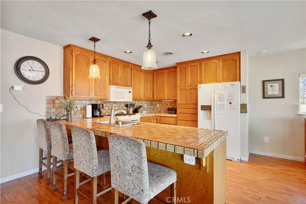 Interior, Kitchen, Pendant Lights, Recessed Lighting, Tile Countertops, Wood Texture Flooring