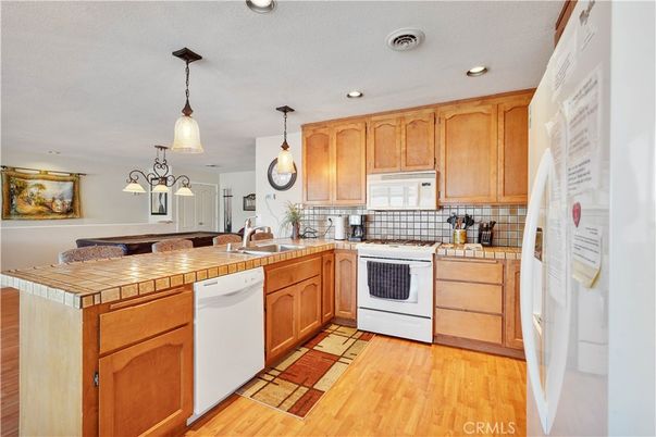 Interior, Kitchen, Pendant Lights, Recessed Lighting, Tile Countertops, Wood Texture Flooring