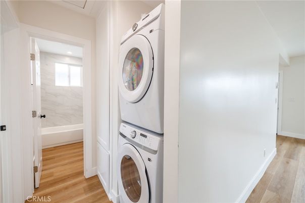 Bathroom, Interior, Marble Walls, Recessed Lighting, Utility Closets, Washer, Wood Texture Flooring
