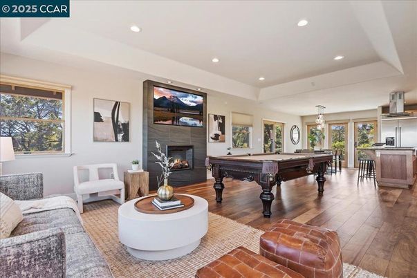 Billiard Table, Fireplace, Game Room, Interior, Living room, Pendant Lights, Recessed Lighting, Wood Texture Flooring
