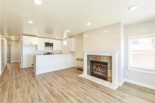 Fireplace, Interior, Kitchen, Recessed Lighting, Stainless Steel Appliances, Wood Texture Flooring