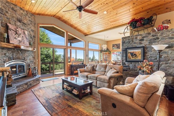 Chandelier, Dining room, Fireplace, Interior, Living room, Recessed Lighting, Stone Walls, Wooden Ceilings, Wood Texture Flooring