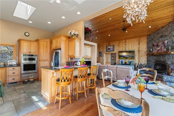 Dining room, Fireplace, Interior, Kitchen, Living room, Recessed Lighting, Stainless Steel Appliances, Stone Walls, Wooden Ceilings, Wood Texture Flooring, Wooden Walls