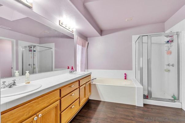 Bathroom, Dual Sink Vanities, Free Standing Baths, Glass Shower, Interior, Recessed Lighting, Tile Countertops, Wood Texture Flooring