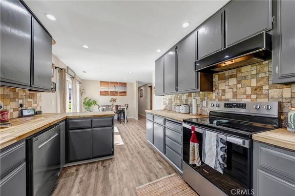 Dining room, Interior, Kitchen, Recessed Lighting, Stainless Steel Appliances, Stone Walls, Wood Texture Flooring