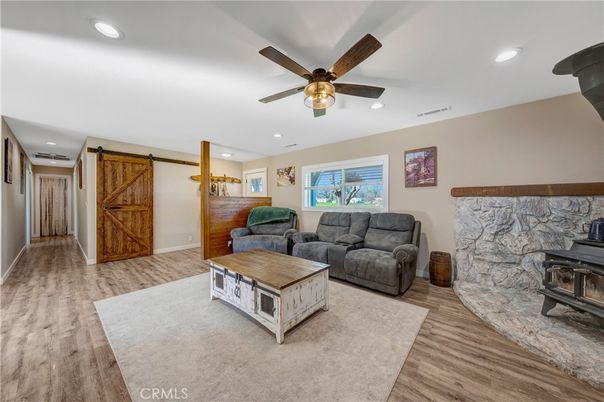 Fireplace, Interior, Living room, Recessed Lighting, Stone Walls, Wood Texture Flooring
