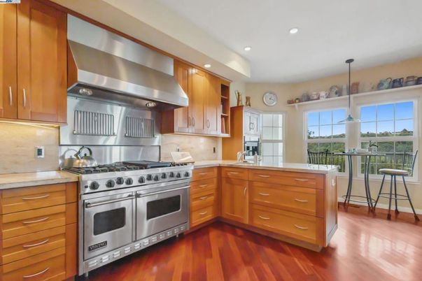 Fireplace, Interior, Kitchen, Recessed Lighting, Stainless Steel Appliances, Wood Texture Flooring