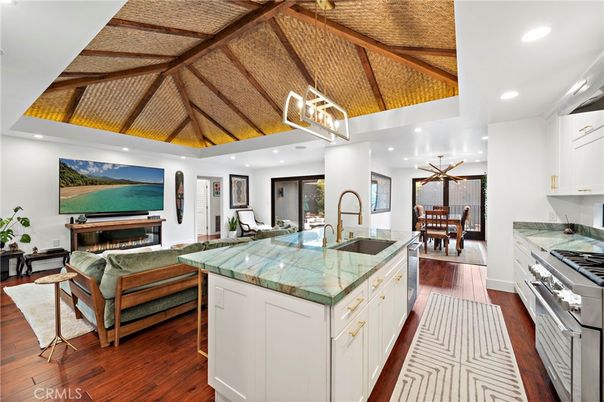 Chandelier, Dining room, Fireplace, Interior, Kitchen, Living room, Pendant Lights, Recessed Lighting, Stainless Steel Appliances, Wooden Beams, Wooden Ceilings, Wood Texture Flooring