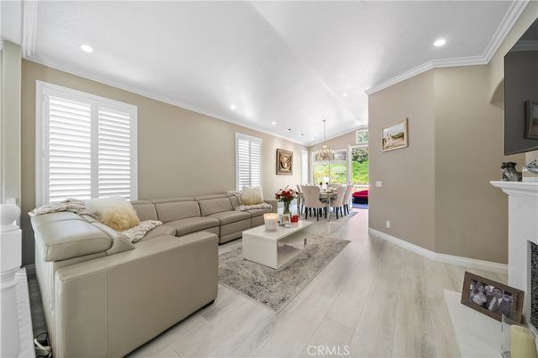 Chandelier, Dining room, Fireplace, Interior, Living room, Pendant Lights, Recessed Lighting, Wood Texture Flooring