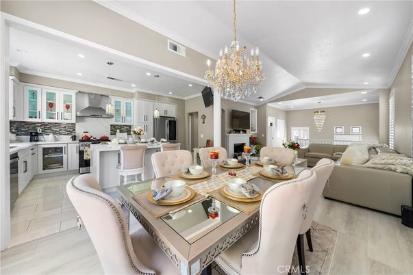 Chandelier, Dining room, Interior, Kitchen, Living room, Pendant Lights, Recessed Lighting, Stainless Steel Appliances, Wood Texture Flooring