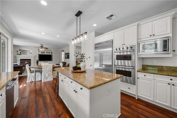 Dining room, Fireplace, Interior, Kitchen, Pendant Lights, Recessed Lighting, Stainless Steel Appliances, Wood Texture Flooring