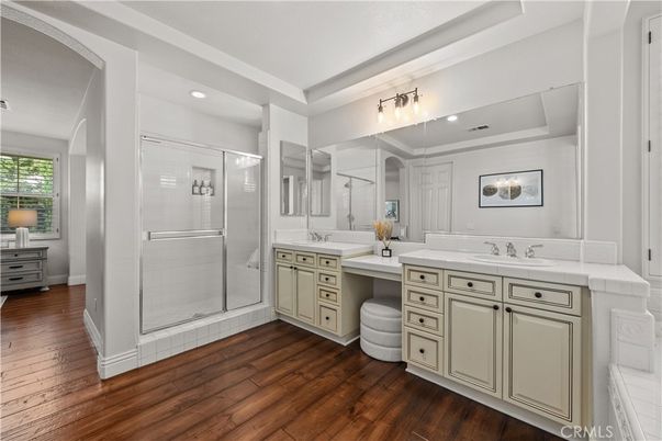 Bathroom, Dual Sink Vanities, Glass Shower, Interior, Recessed Lighting, Tile Countertops, Wood Texture Flooring