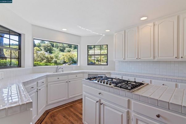 Interior, Kitchen, Recessed Lighting, Tile Countertops, Wood Texture Flooring