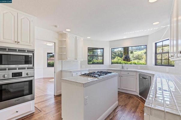 Interior, Kitchen, Recessed Lighting, Stainless Steel Appliances, Tile Countertops, Wood Texture Flooring