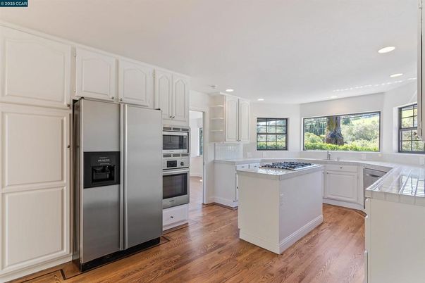 Interior, Kitchen, Recessed Lighting, Stainless Steel Appliances, Tile Countertops, Wood Texture Flooring
