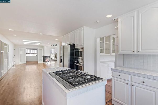 Interior, Kitchen, Recessed Lighting, Stainless Steel Appliances, Tile Countertops, Wood Texture Flooring