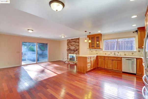Fireplace, Interior, Kitchen, Pendant Lights, Recessed Lighting, Stainless Steel Appliances, Stone Walls, Wood Texture Flooring