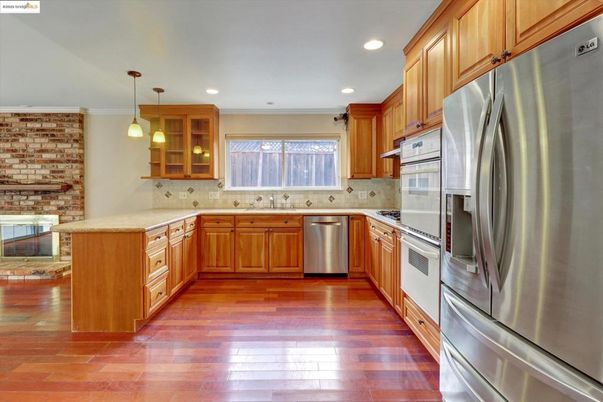 Interior, Kitchen, Pendant Lights, Recessed Lighting, Stainless Steel Appliances, Stone Walls, Wood Texture Flooring