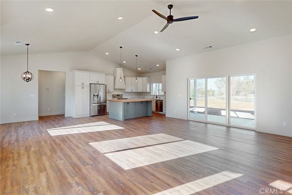 Empty room, Interior, Kitchen, Pendant Lights, Recessed Lighting, Stainless Steel Appliances, Wood Texture Flooring