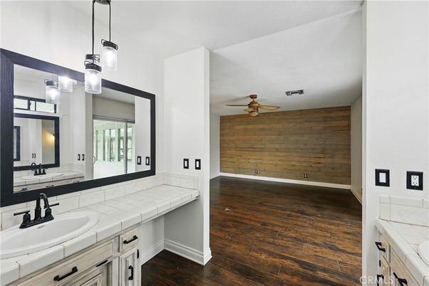 Bathroom, Dual Sink Vanities, Interior, Pendant Lights, Tile Countertops, Wood Texture Flooring, Wooden Walls