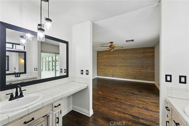 Bathroom, Dual Sink Vanities, Interior, Pendant Lights, Tile Countertops, Wood Texture Flooring, Wooden Walls