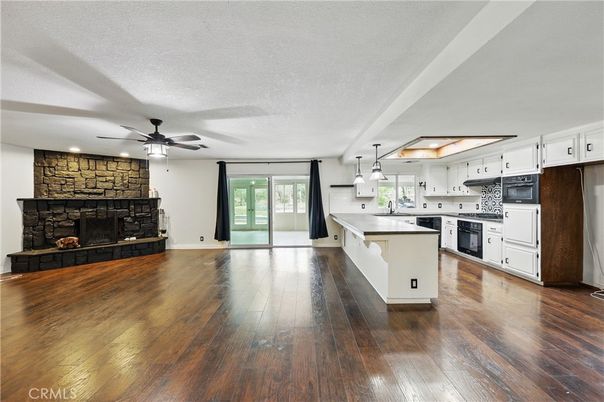 Fireplace, Interior, Kitchen, Pendant Lights, Recessed Lighting, Stone Walls, Wood Texture Flooring