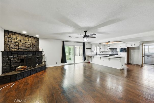 Empty room, Fireplace, Interior, Kitchen, Recessed Lighting, Stone Walls, Wood Texture Flooring