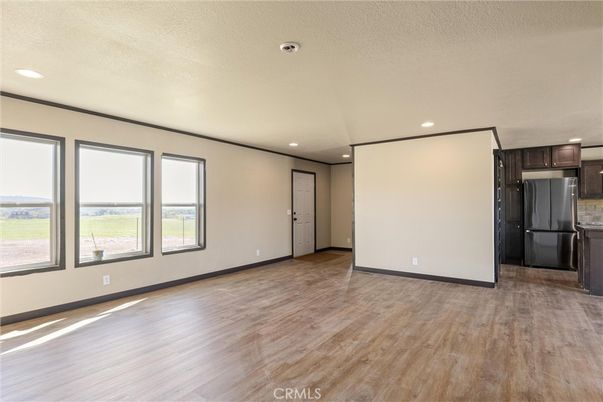 Empty room, Interior, Kitchen, Recessed Lighting, Stainless Steel Appliances, Wood Texture Flooring